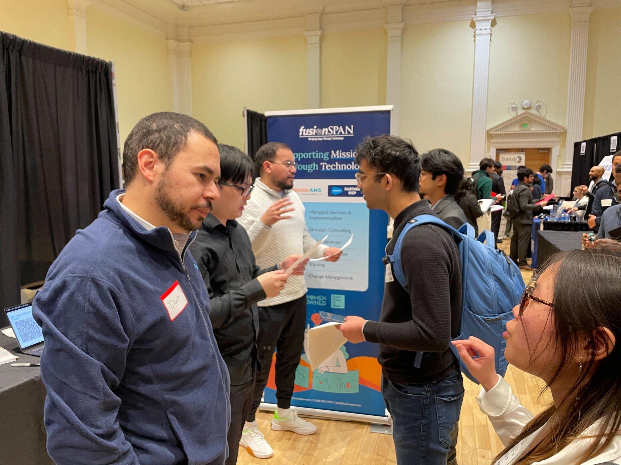 A busy afternoon at the fusionSpan booth — students lined up to learn more about career opportunities.